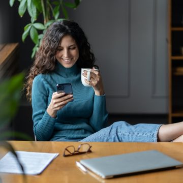 Remote worker girl procrastinate at workplace sit at desk with closed laptop chat in social media